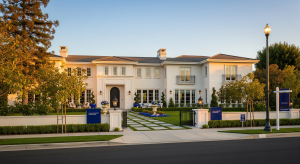 Large luxury estate with manicured landscaping and grand architectural design.